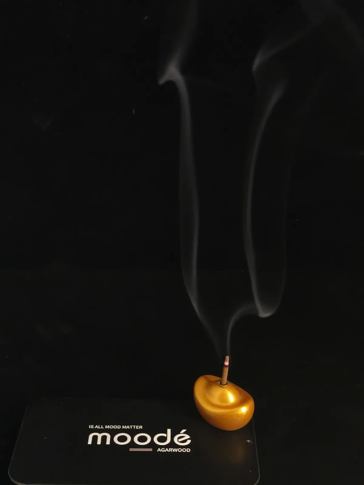 Incense burning in a gold ingot holder